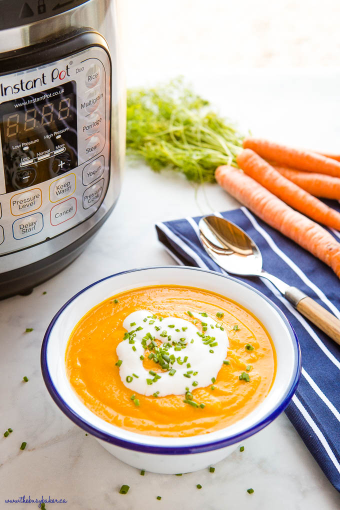 white bowl with blue rim, with carrot ginger soup