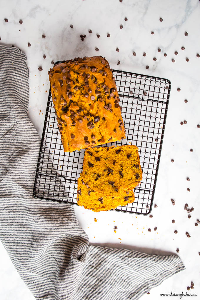 overhead image: pumpkin loaf with chocolate chips on black wire rack
