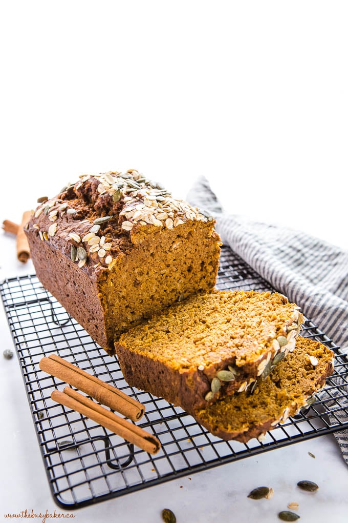 pumpkin oat bread on black wire rack with oats and cinnamon