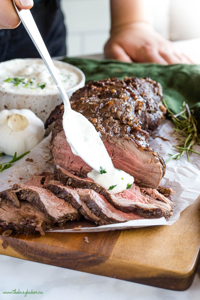 horseradish sauce on slices of medium rare beef tenderloin