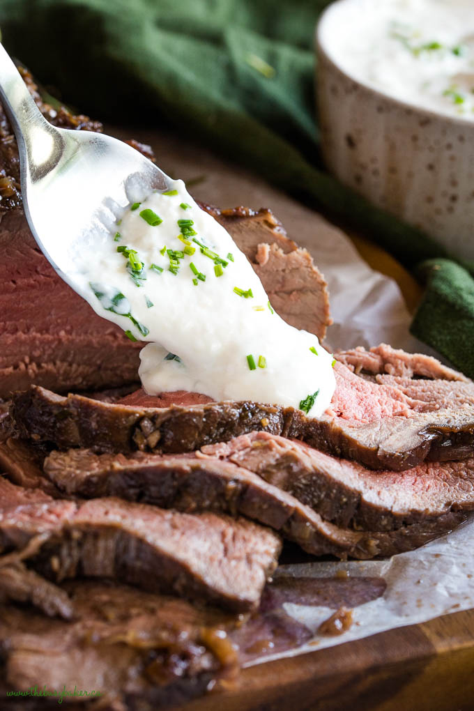 sliced roast beef with a spoonful of creamy horseradish sauce