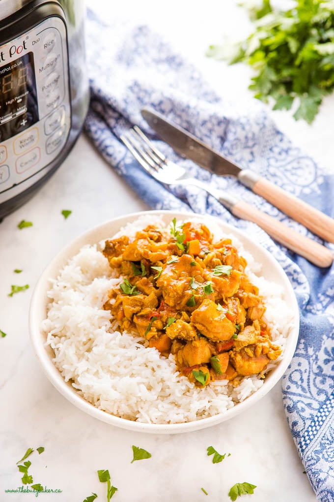 butter chicken made in the Instant Pot over rice in a white bowl