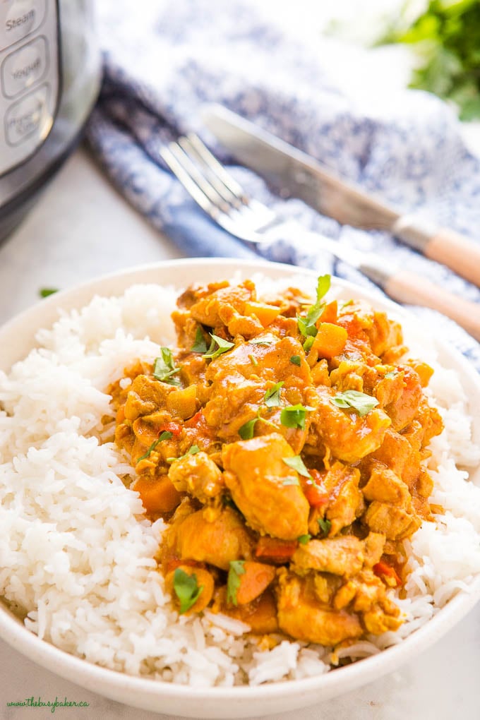 closeup image: instant pot butter chicken over rice in a white bowl