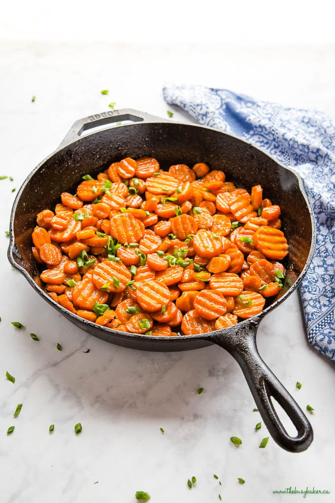 cast iron skillet with crinkle cut honey glazed carrots