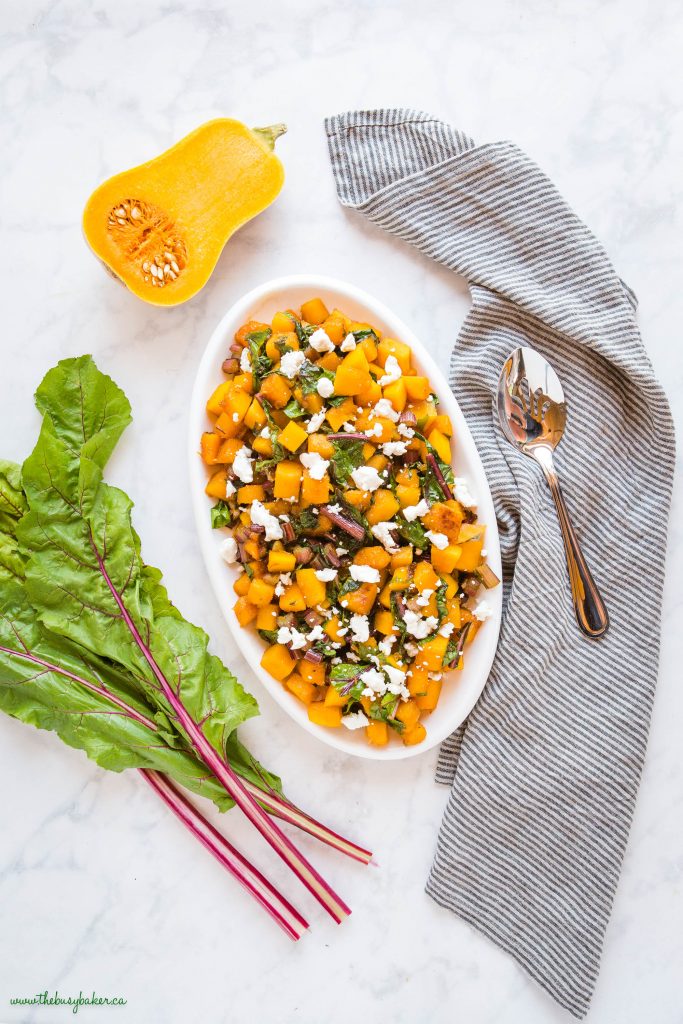 overhead image: caramelized butternut squash with greens and goat cheese