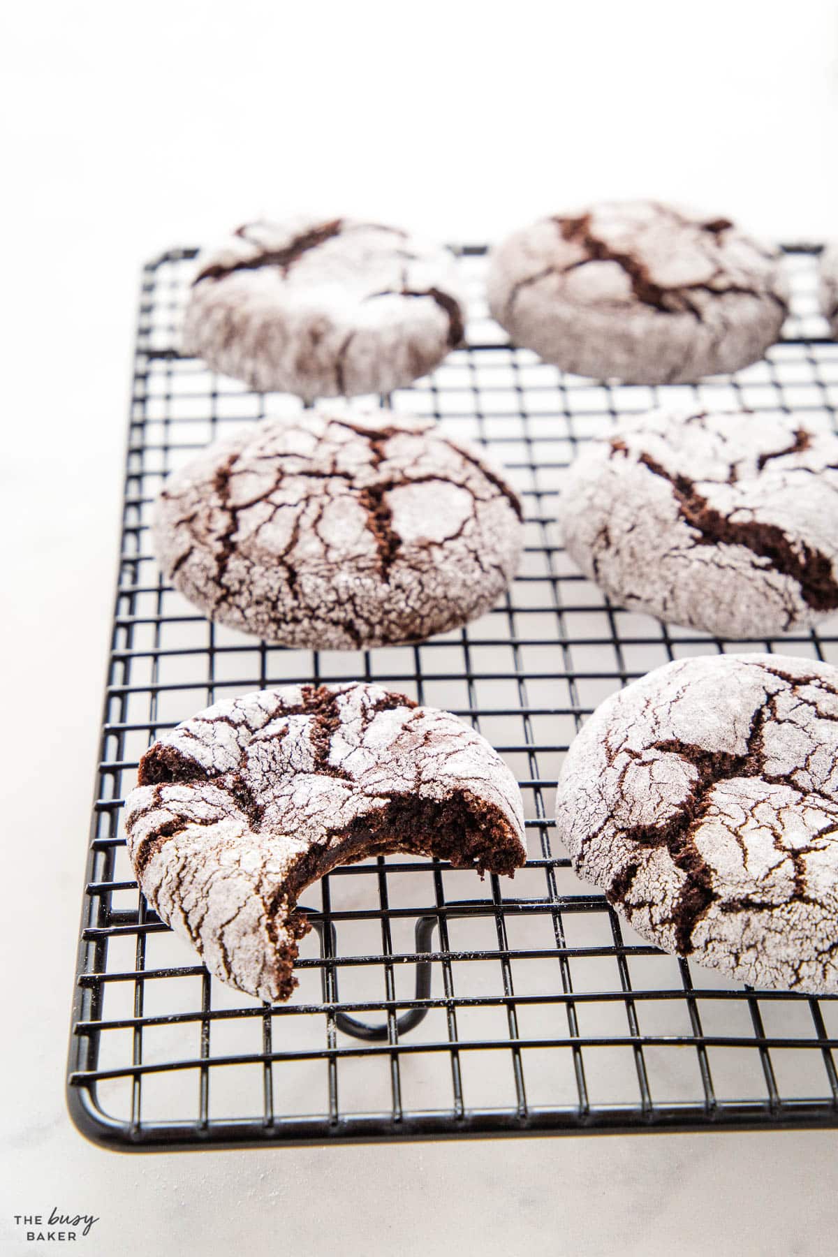 chocolate christmas cookies coated in sugar on a cooling rack