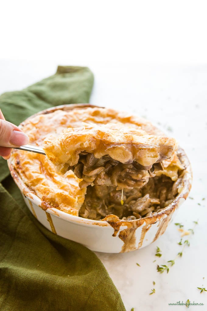 hand serving vegetarian mushroom pot pie