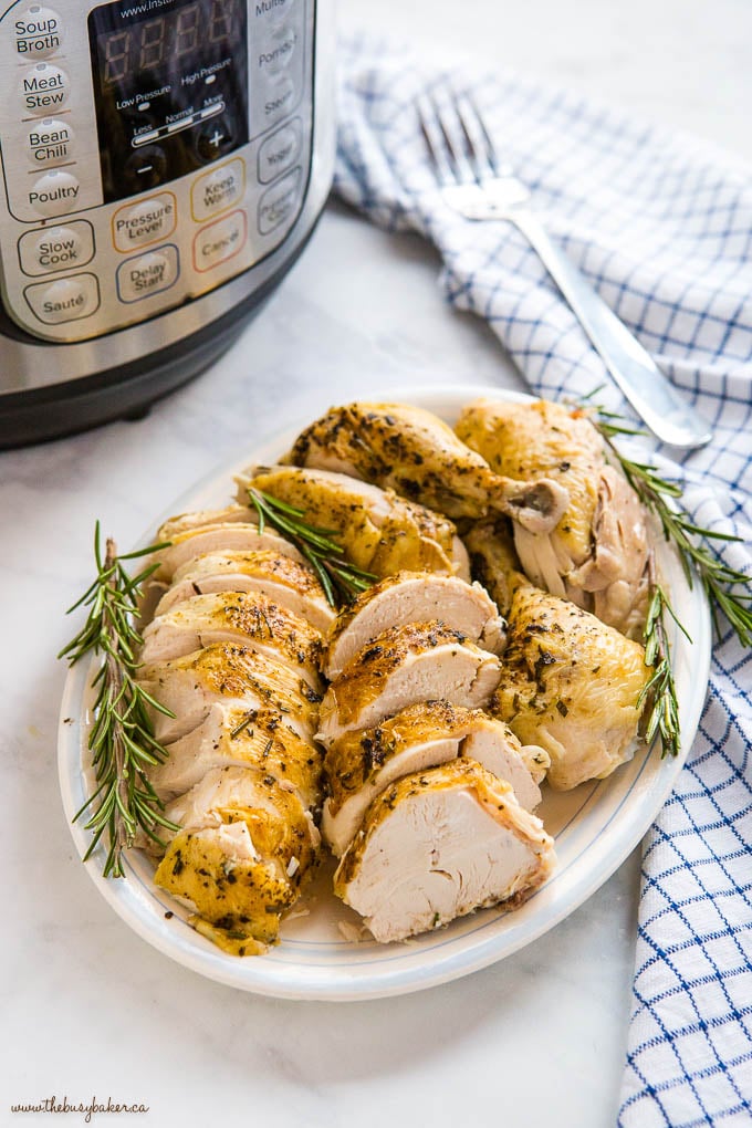 Instant Pot Roasted Chicken on platter with fresh rosemary