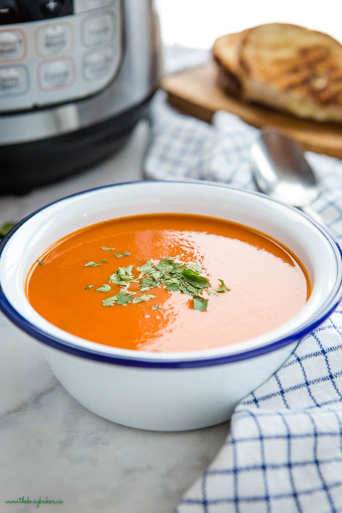 tomato soup in white bowl with blue rim