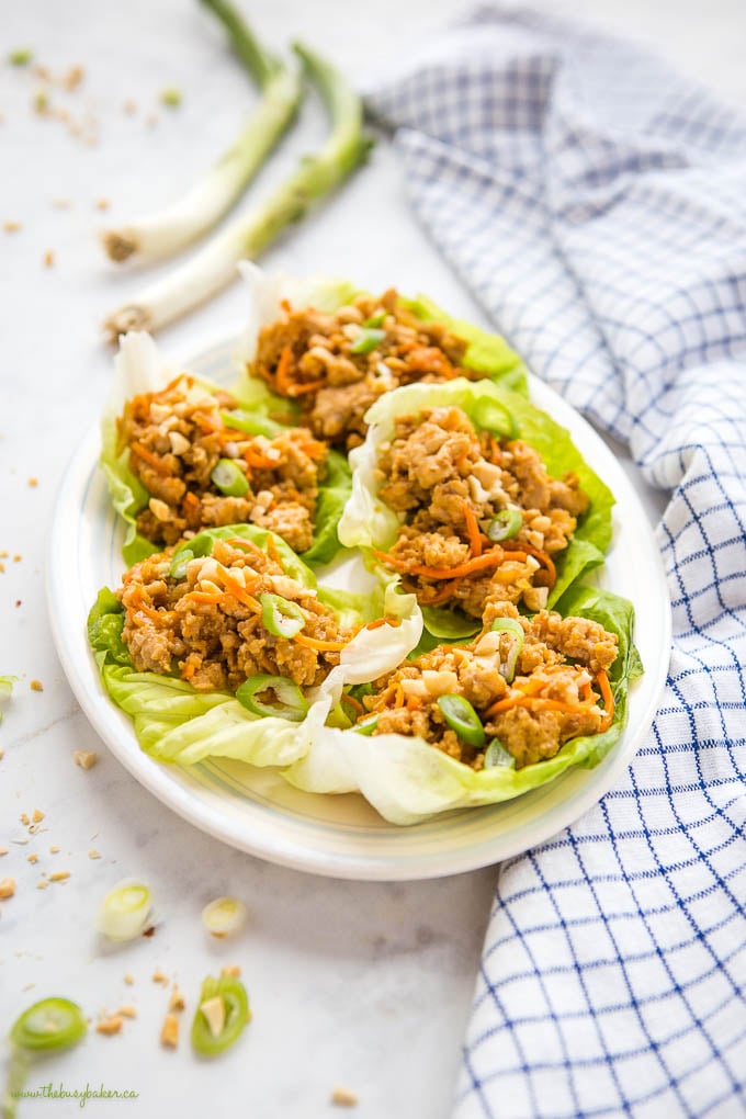 plate of chicken lettuce wraps with carrots and green onions