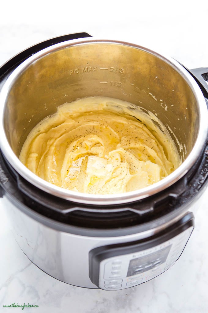 instant pot with mashed potatoes, melted butter and black pepper