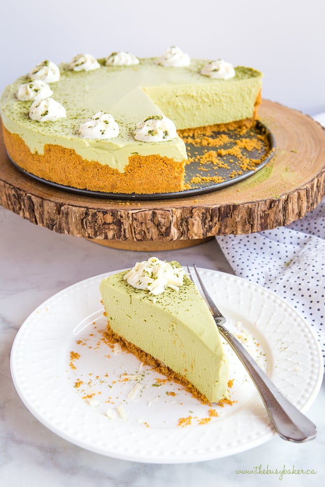 slice of green tea matcha cheesecake on white plate with fork