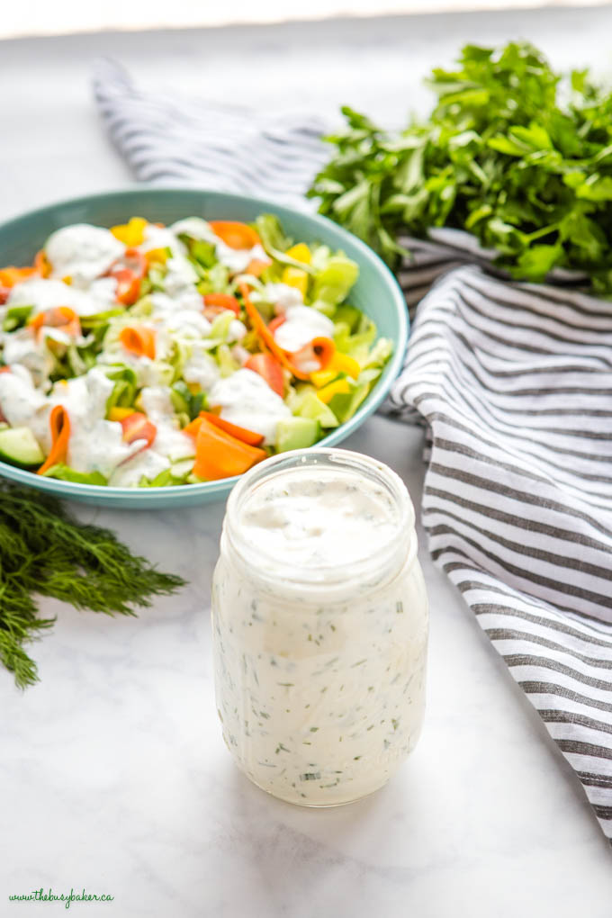 homemade ranch dressing in a mason jar with salad