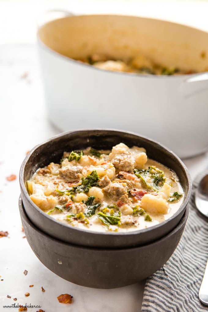 keto zuppa toscana in black bowls with white pot in background