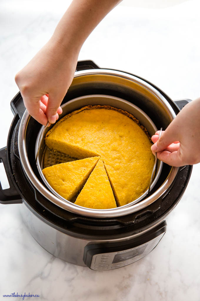 hands lifting cornbread out of the Instant Pot