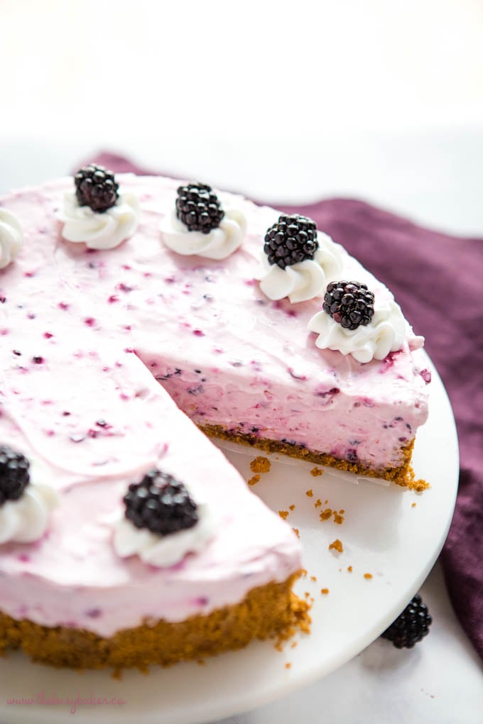creamy blackberry cheesecake on marble cake stand