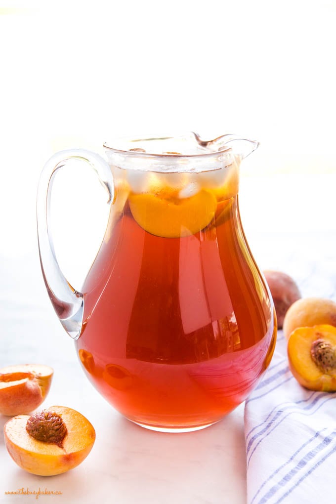 pitcher of peach tea with fresh peaches