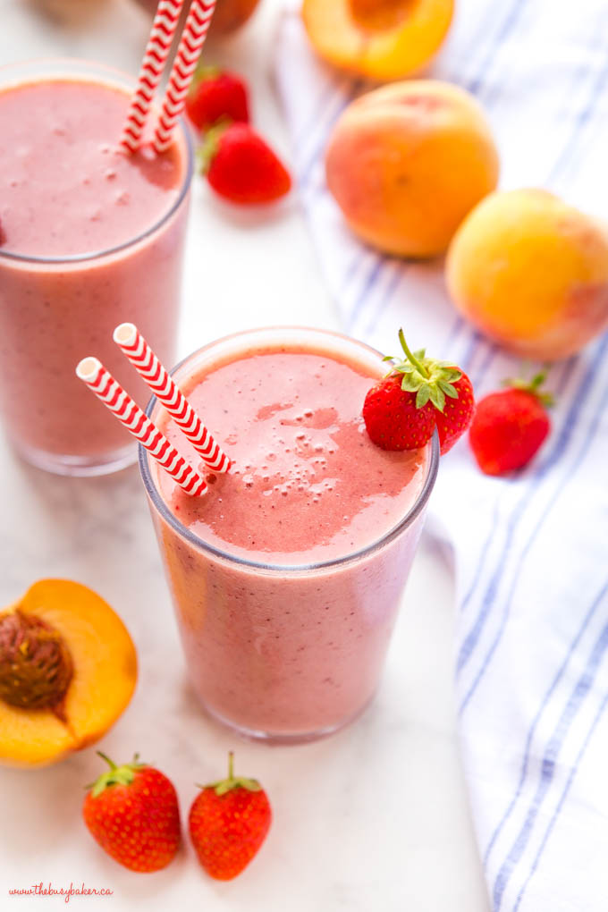 closeup image: strawberry peach smoothie with fresh strawberries and peaches