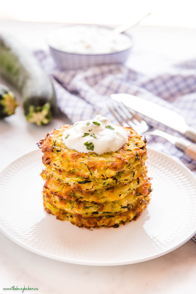 stack of baked zucchini fritters with tzatziki sauce