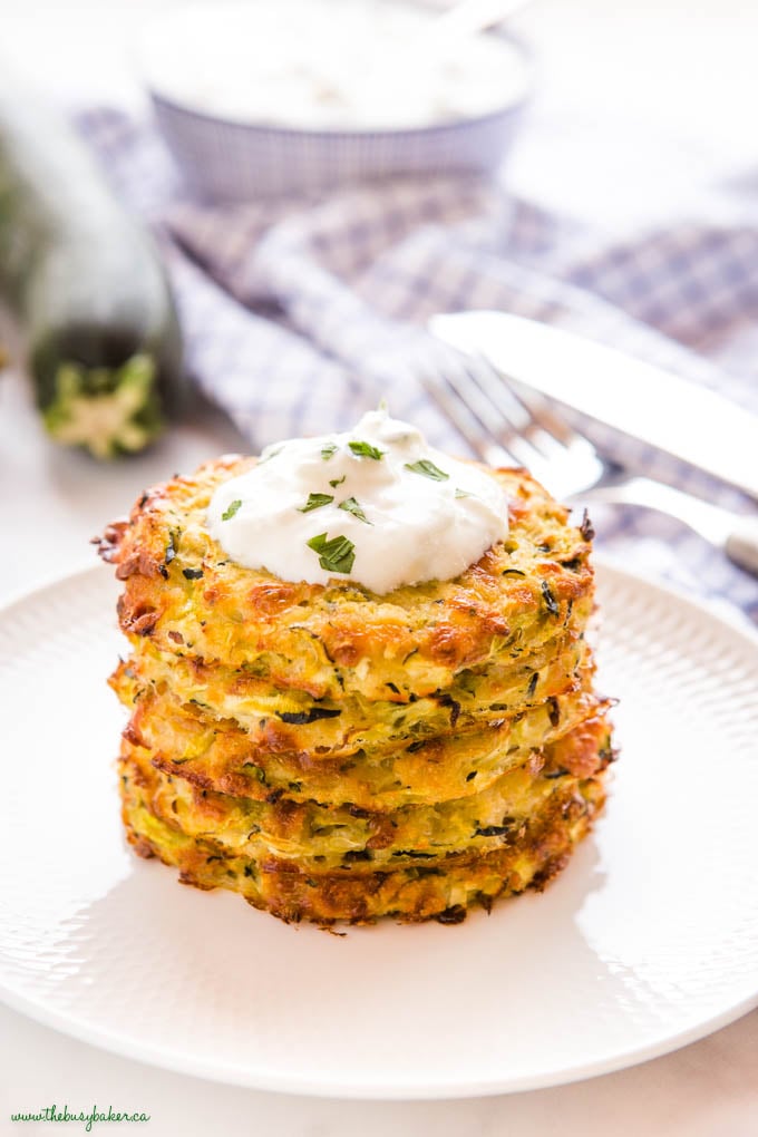 stack of baked zucchini fritters with tzatziki sauce