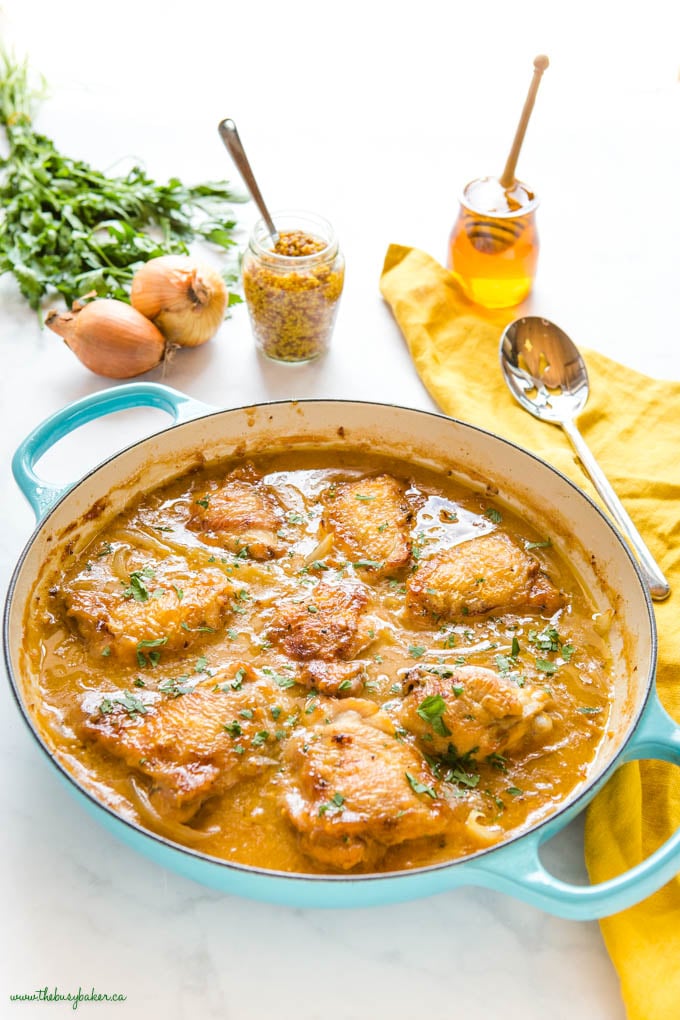 honey mustard chicken thighs in blue cast iron pan