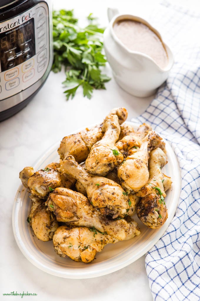 chicken drumsticks on a platter with gravy