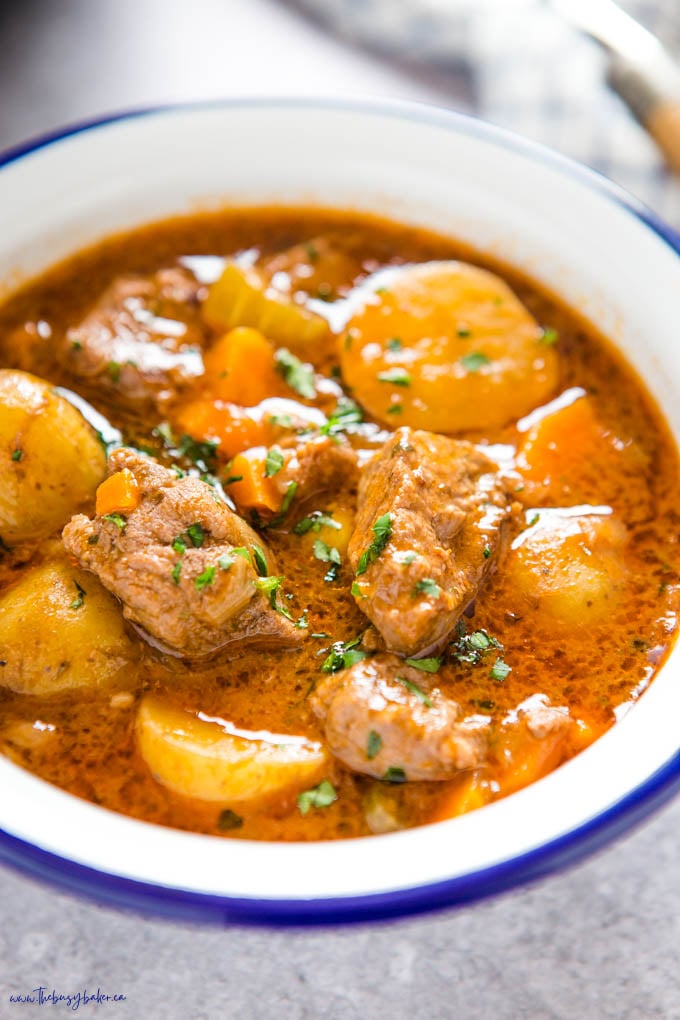 instant pot beef stew in white bowl withe blue rim