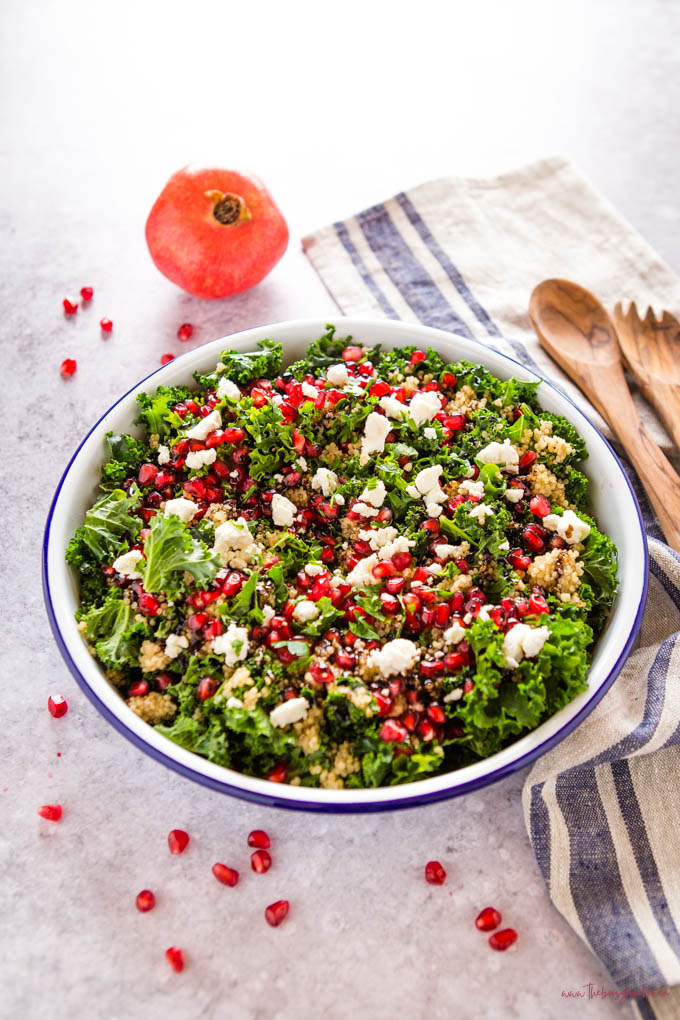 pomegranate salad with kale in a white bowl