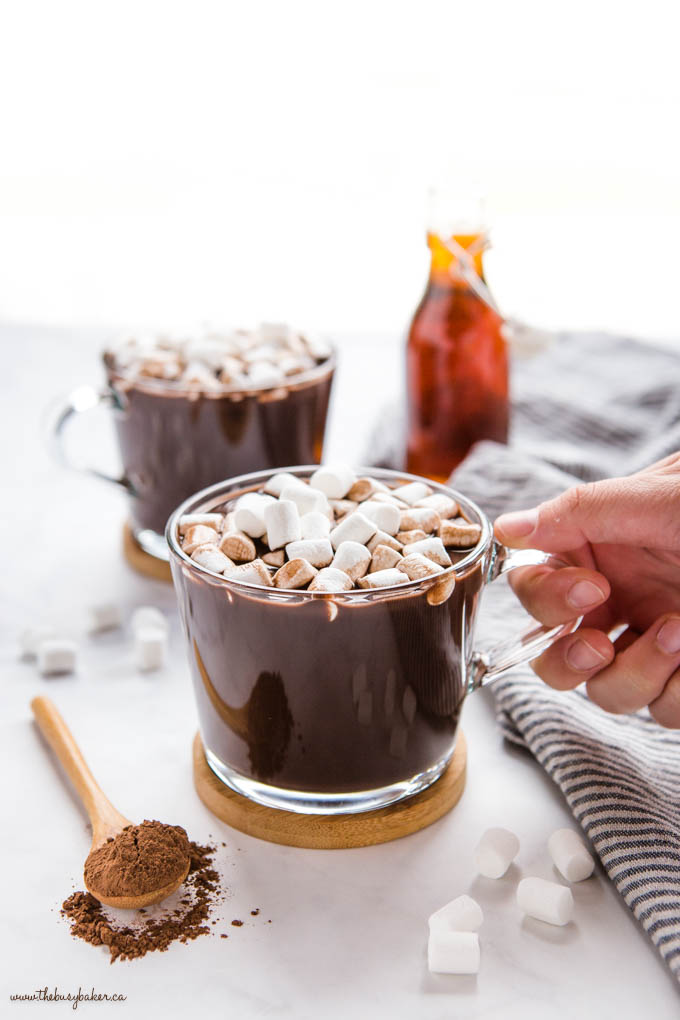 hand holding glass mug with homemade vegan hot chocolate