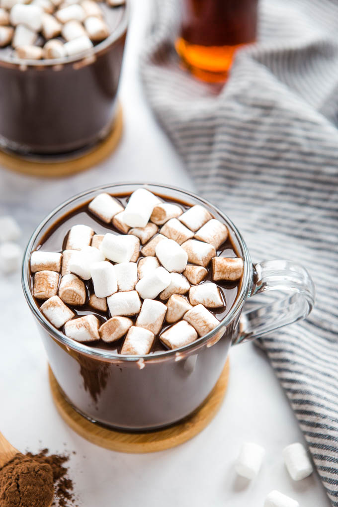 vegan hot chocolate in glass mug with plant-based marshmallows on top