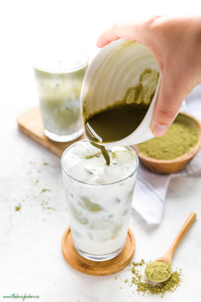 pouring matcha into glass with ice