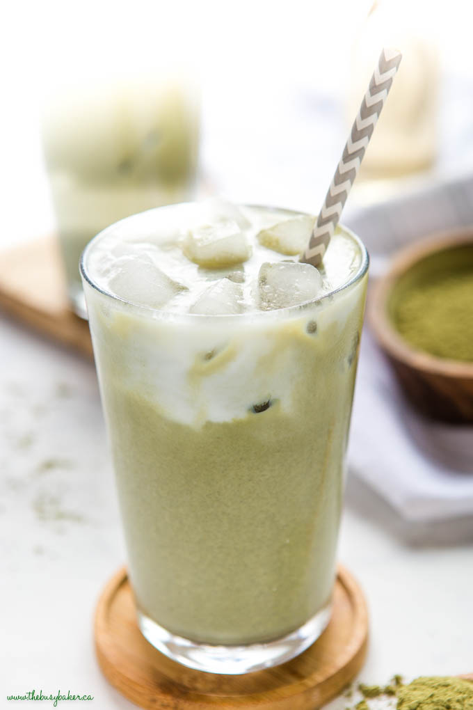 matcha latte with ice in glass with paper straw