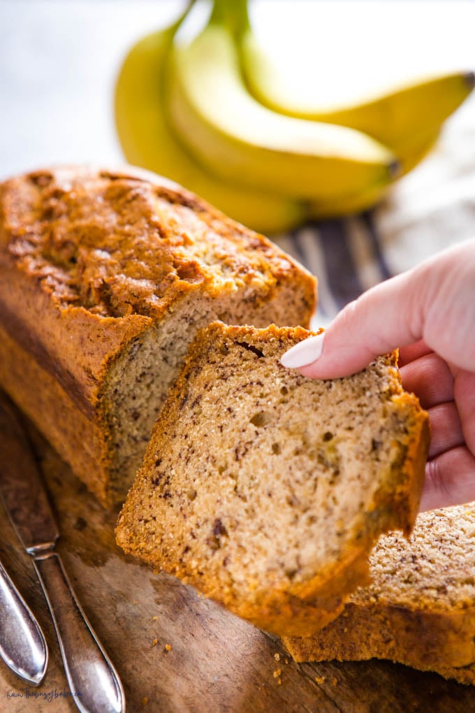 hand holding a slice of vegan banana bread