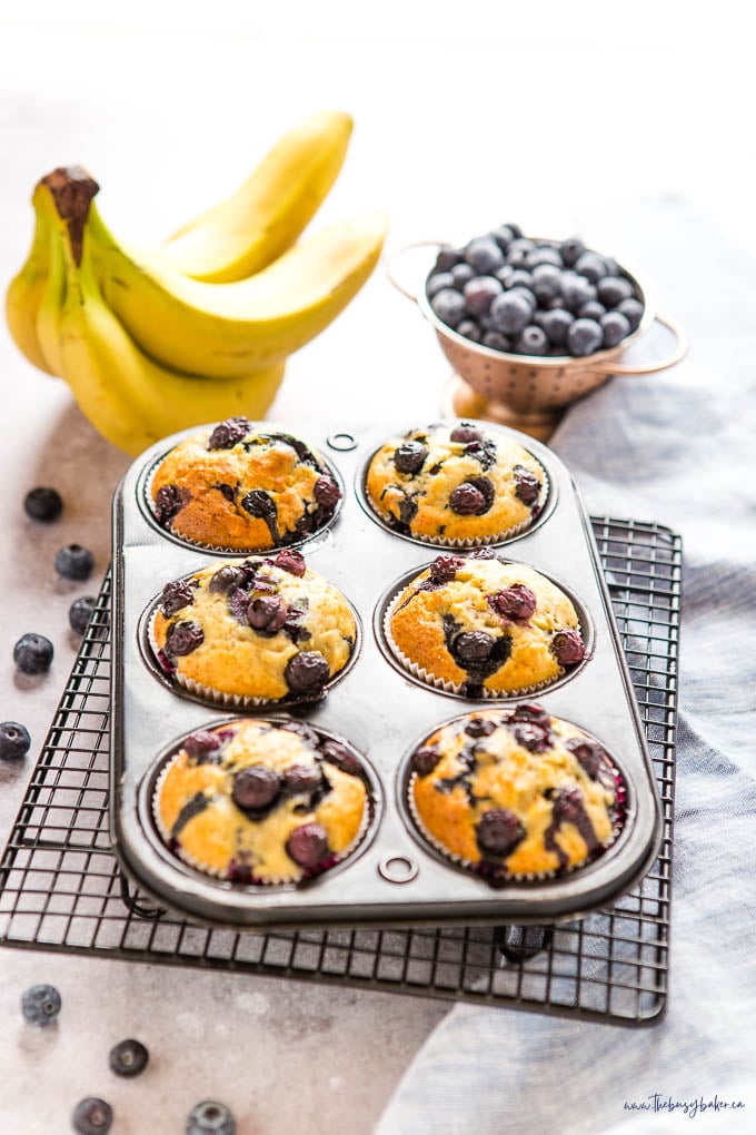 banana blueberry muffins in black muffin tin