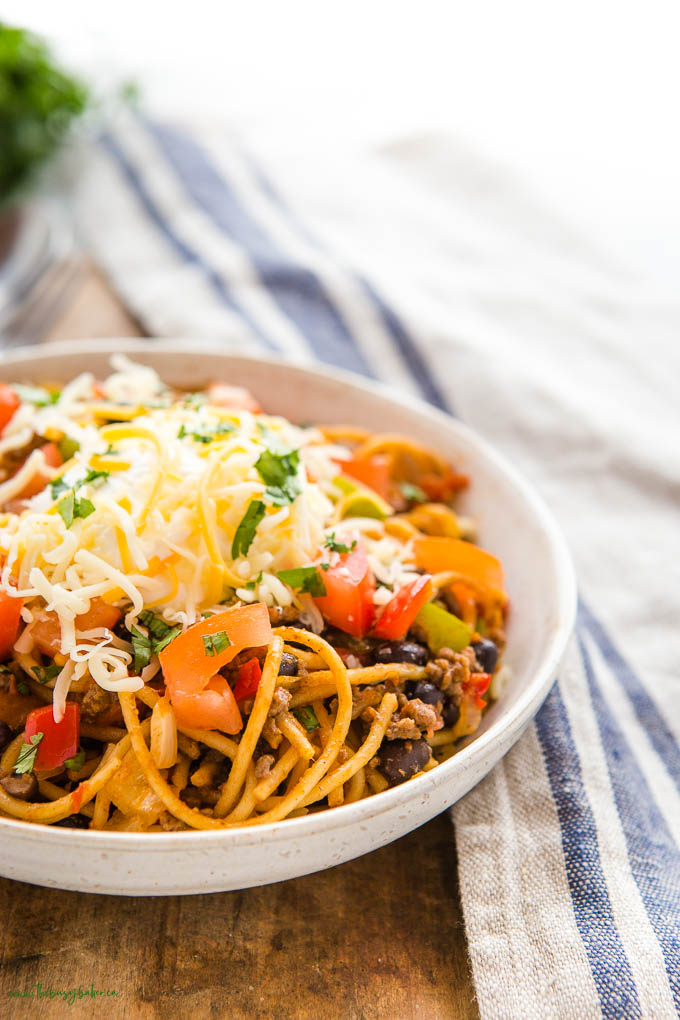 mexican pasta with tomatoes, beef, black beans, sour cream and cheese