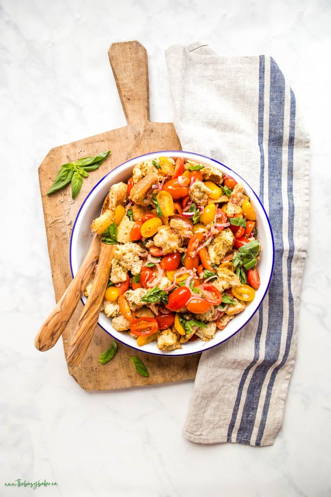 overhead image: tuscan panzanella salad in white enamel bowl