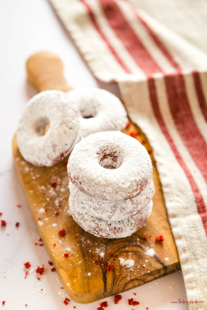 stack of red velvet donuts with powdered sugar