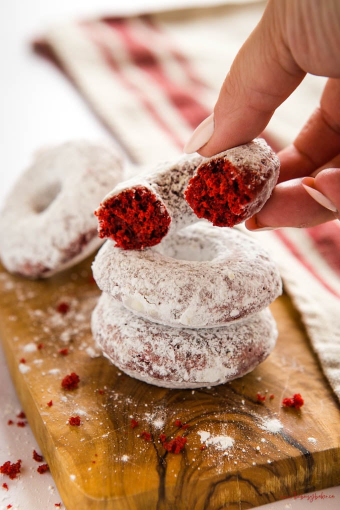 hand holding red velvet donut