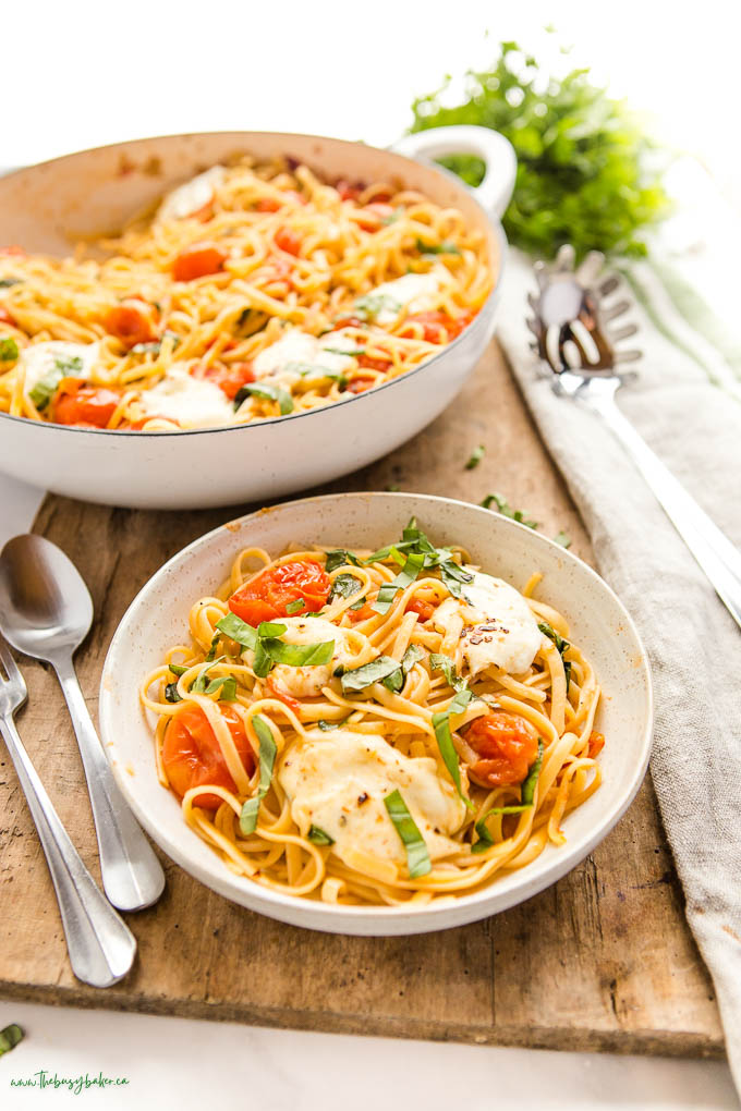 bowl of pasta with mozzarella, basil and tomatoes