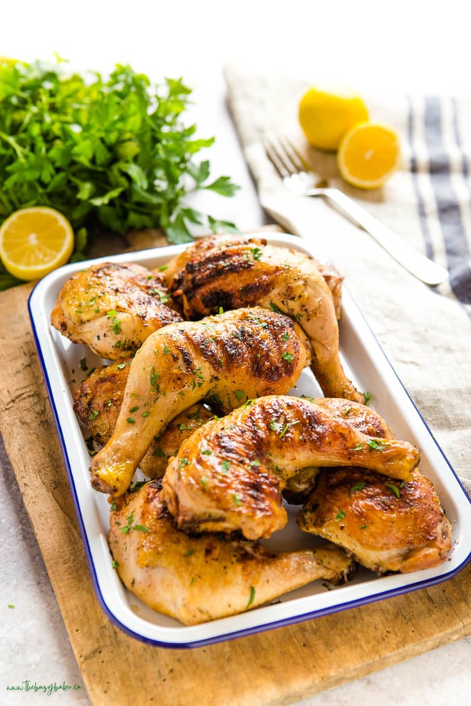grilled chicken legs on white platter