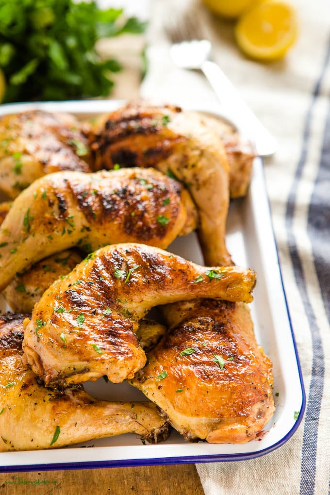 grilled chicken legs on white platter