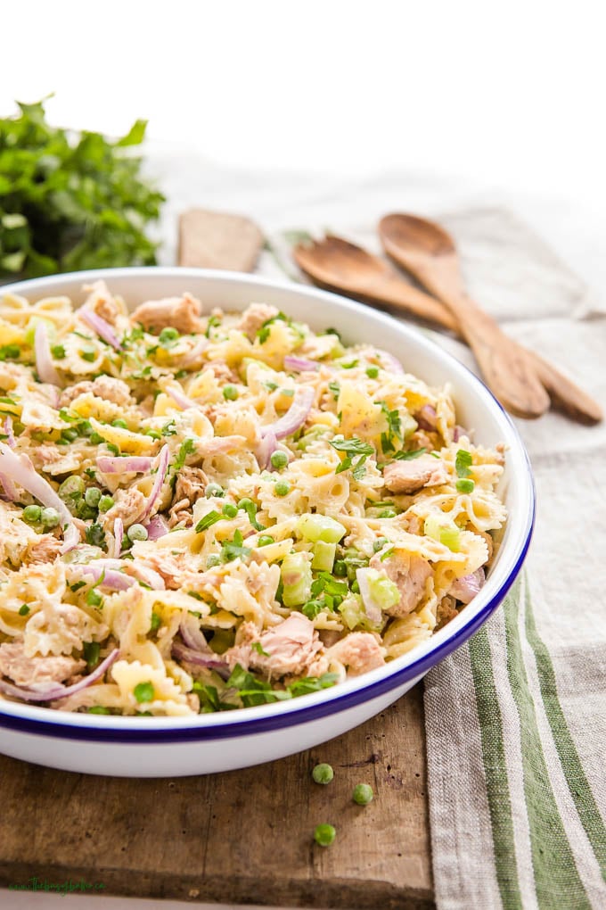  tuna salad in white bowl on a wood cutting board