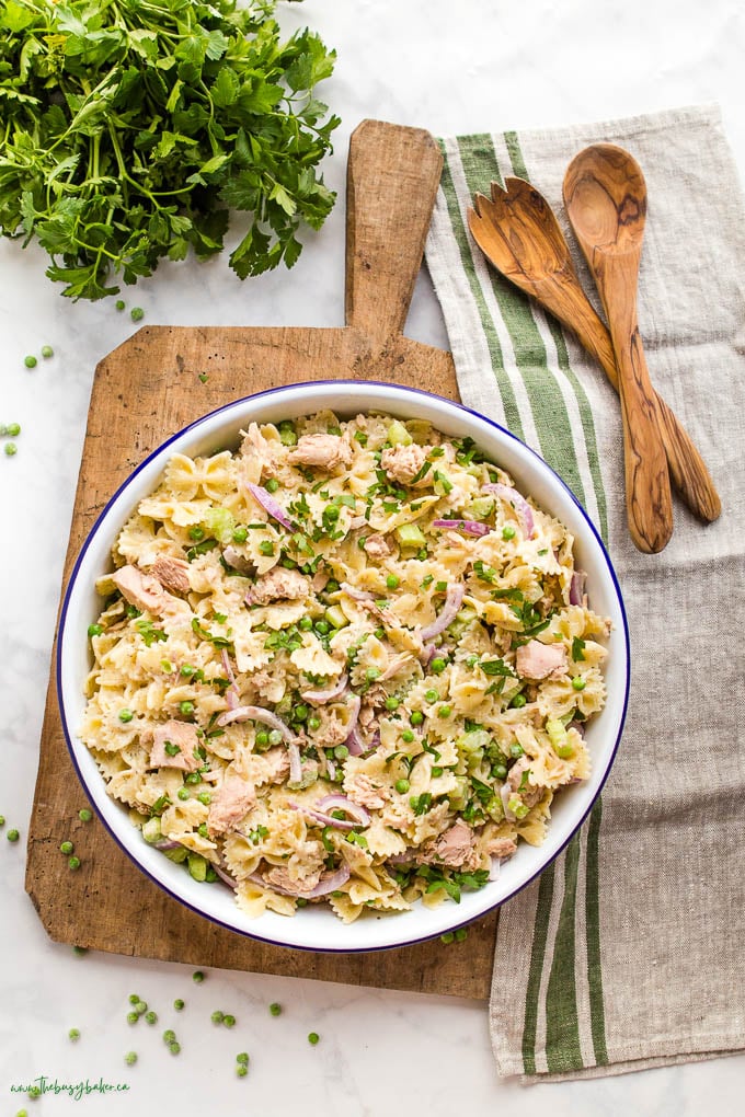 overhead image of tuna salad in white bowl sitting on wood cutting board