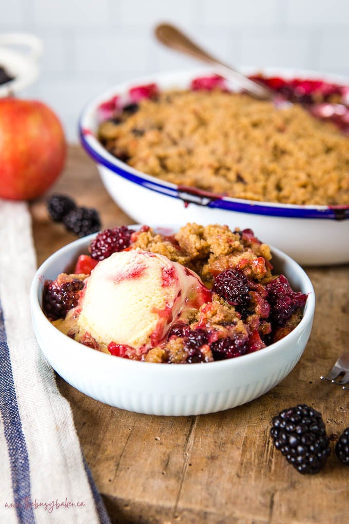 fruit crumble with ice cream in light blue bowl