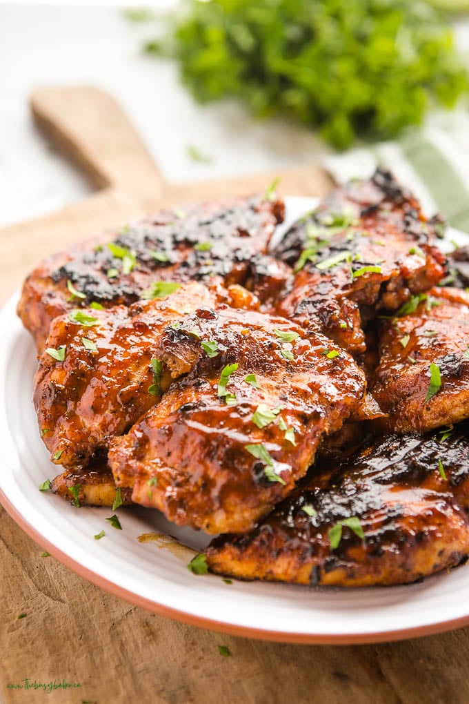 close up of bbq chicken on white plate