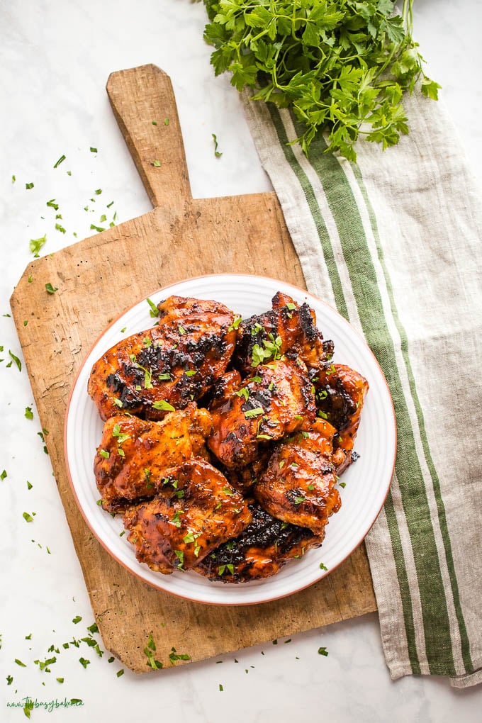 bbq chicken on plate, next to a green striped towel