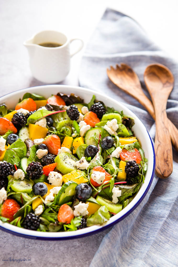 salad with fruits in white bowl
