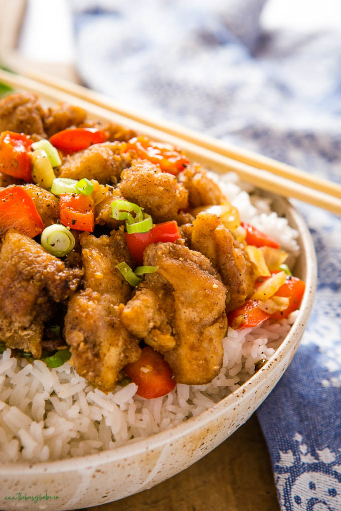 closeup image: salt and pepper chicken over rice