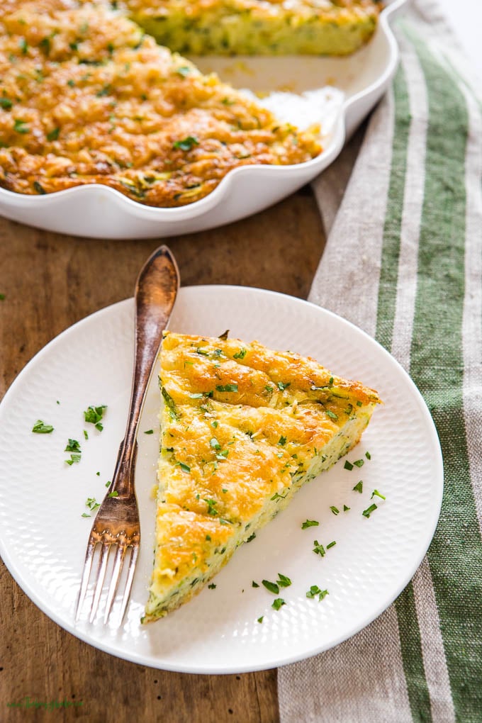 zucchini slice on white plate beside a fork