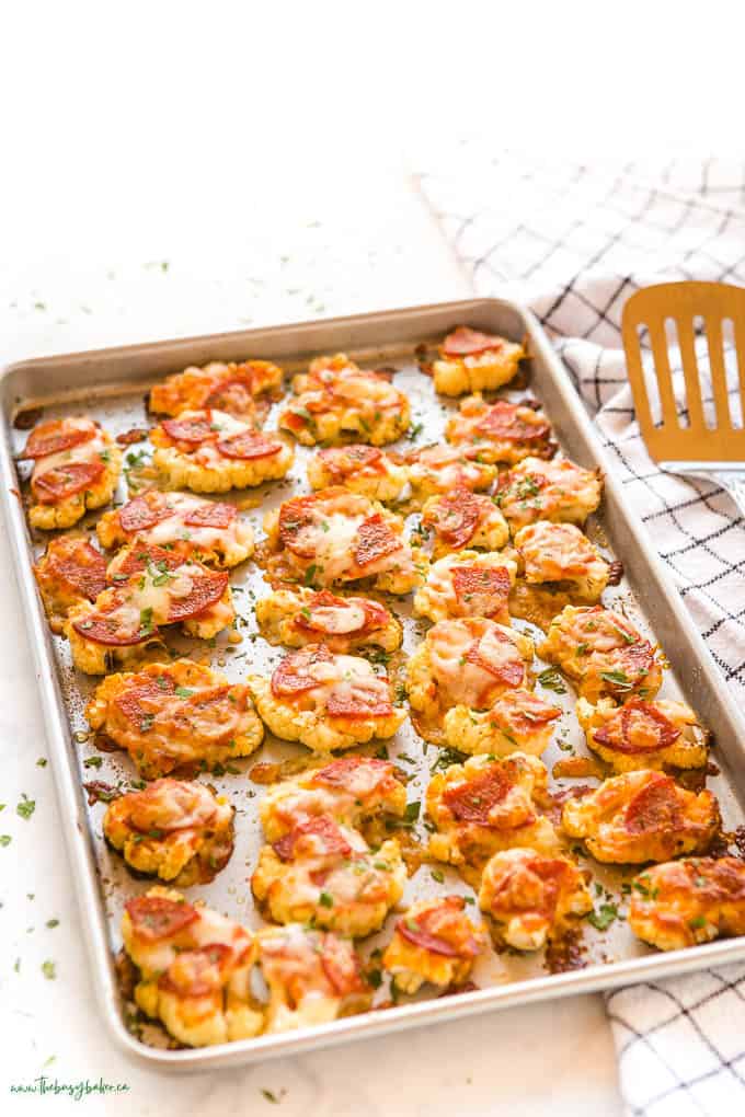 sheet pan with roasted cauliflowerwith marinara sauce and pizza toppings